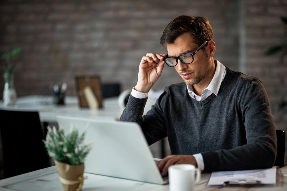 mid-adult-businessman-using-computer-while-working-office_637285-740